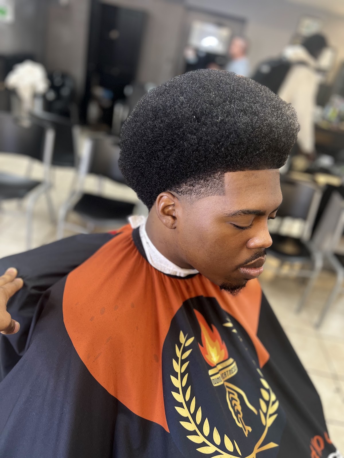 High-top afro fade haircut done at Gloria Hair Salon