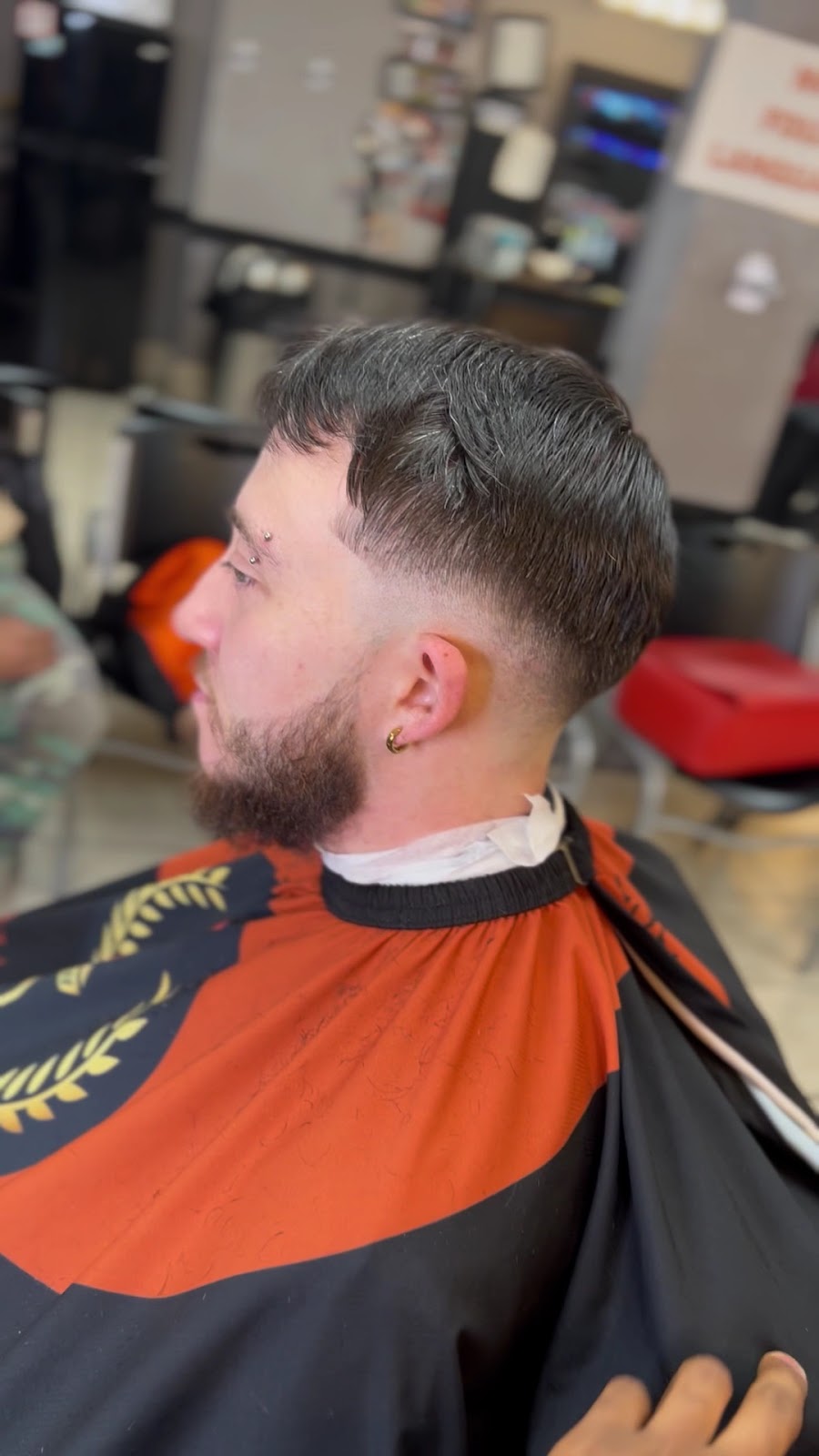 Low taper fade with full beard trim done at Gloria Hair Salon